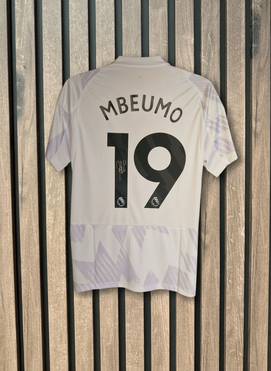 Mbeumo signed shirt with wooden background