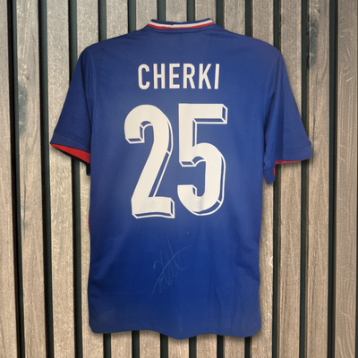 Cherki 25 Signed Shirt on Wood Background