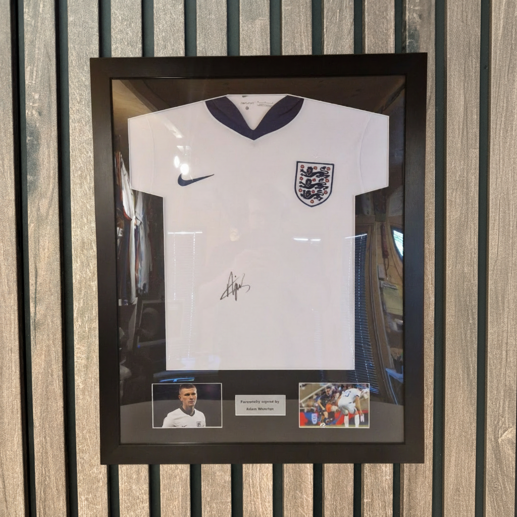 Framed England shirt on wooden background